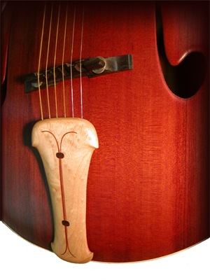 Maple tailpiece on a redwood archtop guitar